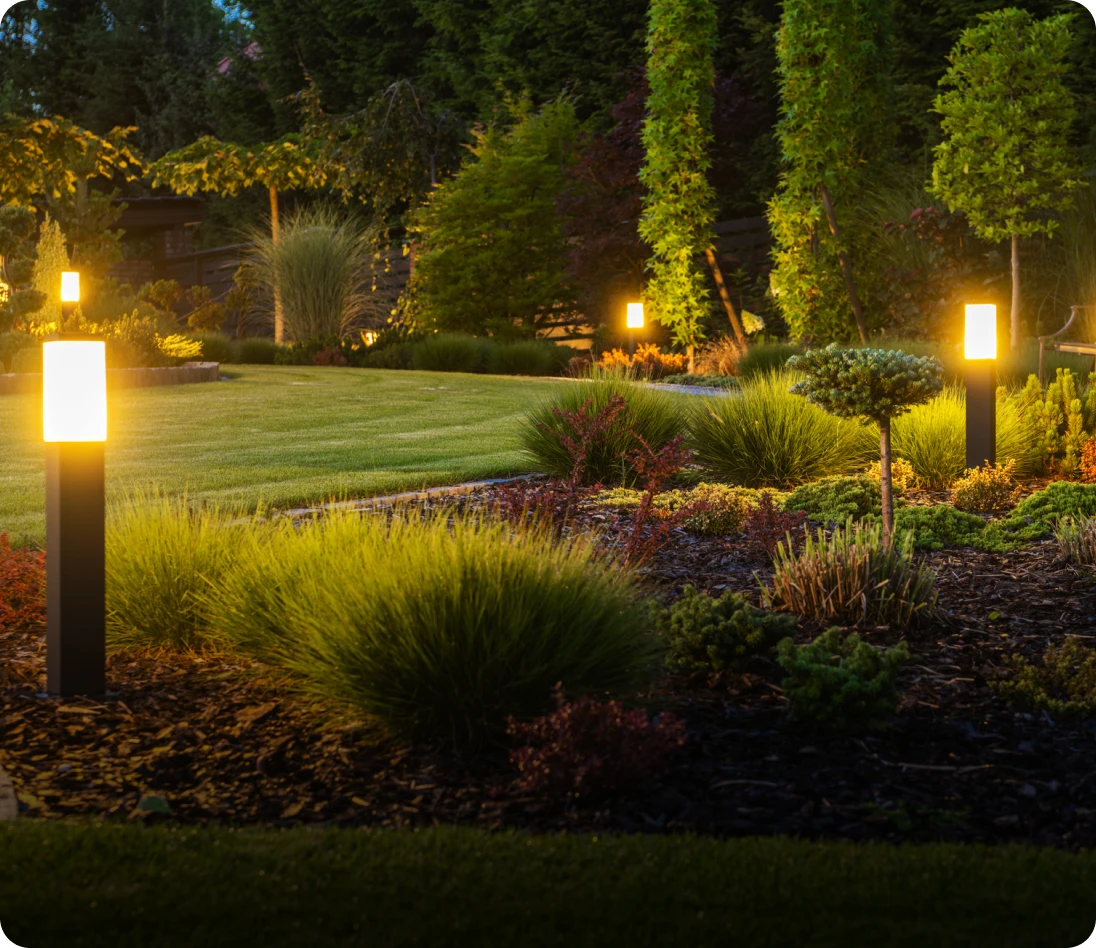 Garden with glowing path lights at dusk.